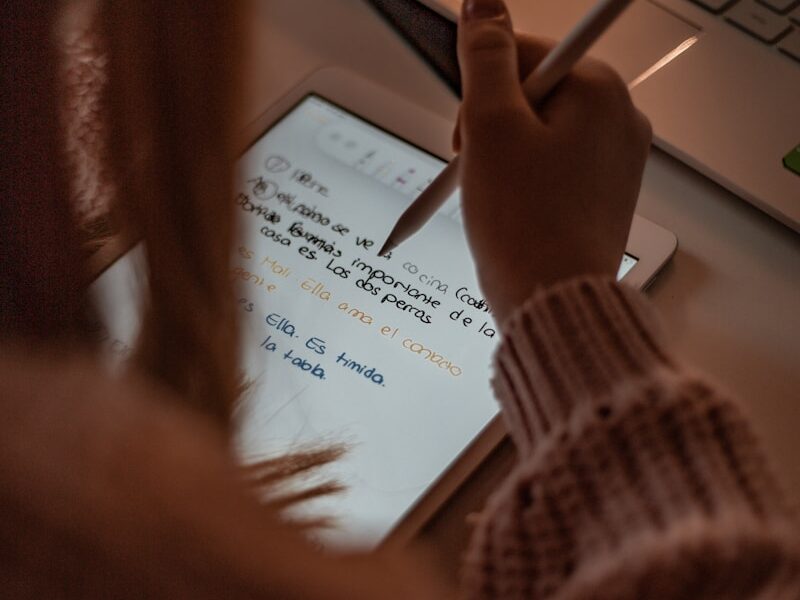 person writing on white paper